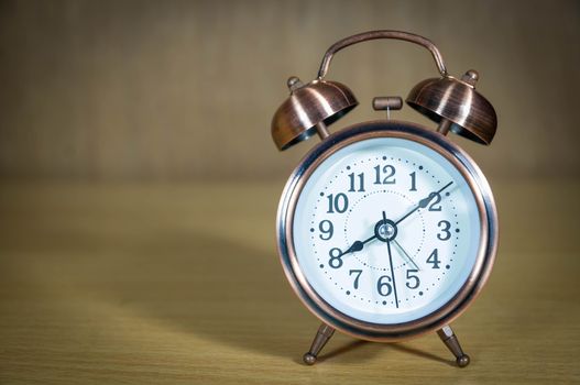 Vintage background with retro alarm clock on table