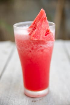 Smoothie water melon with slice water melon on wooden table.