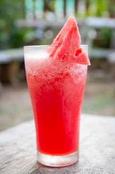 Smoothie water melon with slice water melon on wooden table.