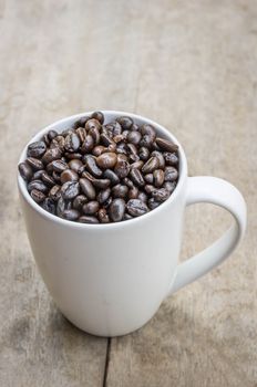 Coffee bean with Cup on wood table.