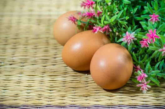 Chicken brown eggs with flowers.