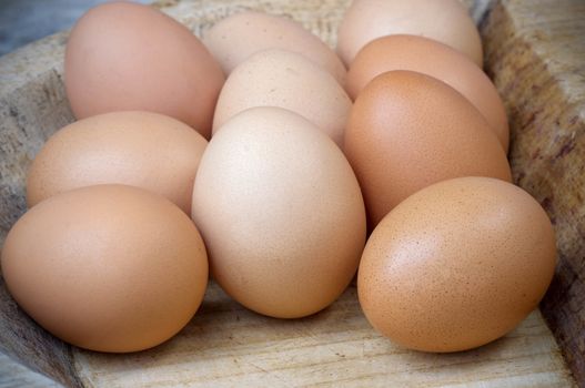 Chicken brown eggs on wood.