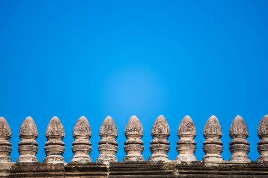 Old brick wall with blue sky background.