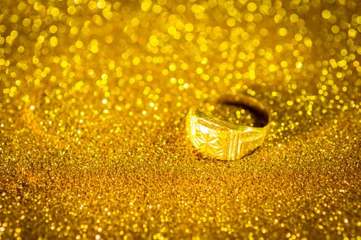 Golden Ring on bokeh gold colour abstract background.