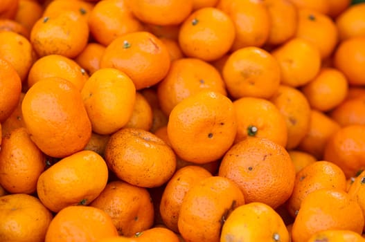 many fresh raw orange in market.