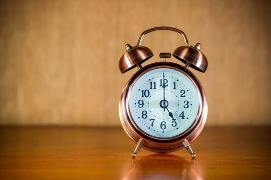 Vintage background with retro alarm clock on table