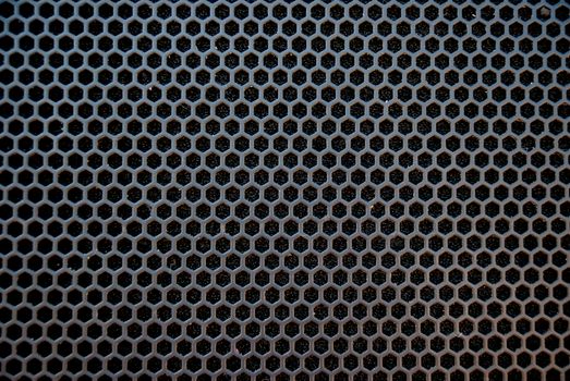 Black speaker grid texture. Industrial background.