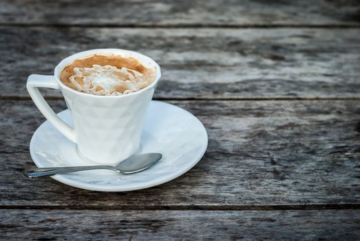 Coffee in a cup on wood background