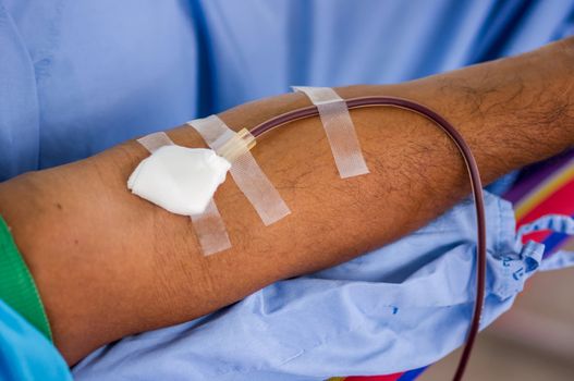 Closeup of blood donor at donation.