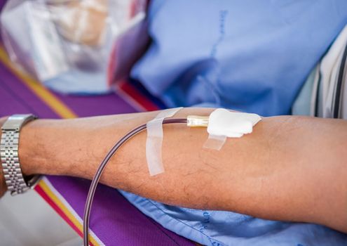 Closeup of blood donor at donation.