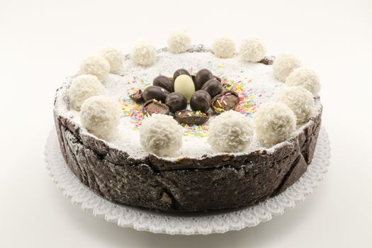 Easter cake with ricotta and chocolate decorated with chocolate eggs and powdered sugar