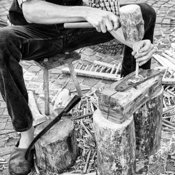 Artisan builds wooden rakes to gather the hay after mowing.