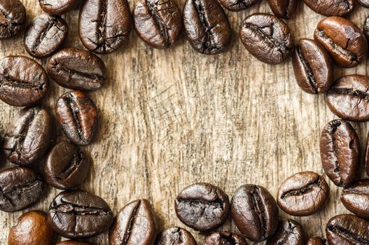 Coffee bean on grunge wooden background.