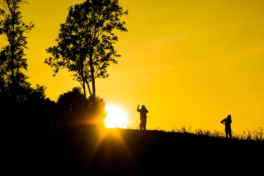 Silhouette sunrises and the man on moutain at Thailand.