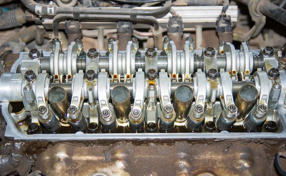 Repairing gasoline engine closeup of camshaft and valves.