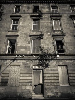 Black And White Image Of A Derelict And Boarded Up Hotel