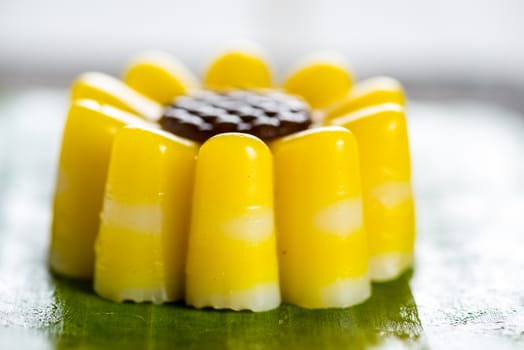 Yellow jelly dessert looking like a flower made with coconuts and pumpkin