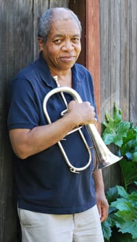 African american male expressions outdoors with his flugelhorn.