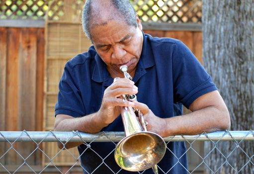 African american male expressions outdoors with his flugelhorn.