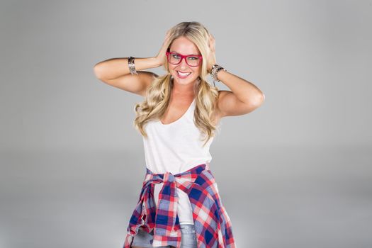 A blonde model posing in a studio environment