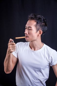 Man Casual portrait-smoking cigar on black background