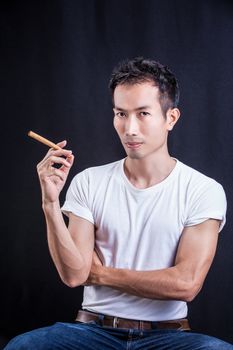 Man Casual portrait-smoking cigar on black background