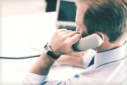 business, office, school and education concept - businessman talking on the phone