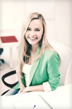 education concept - smiling student girl studying in college