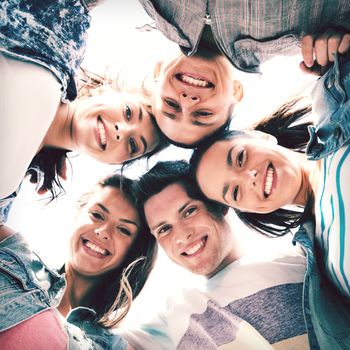 summer holidays and teenage concept - group of teenagers looking down