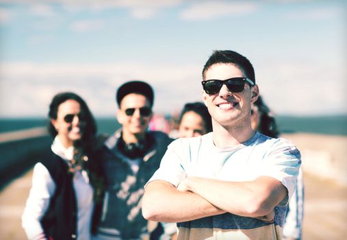 summer holidays and teenage concept - teenager in shades outside with friends