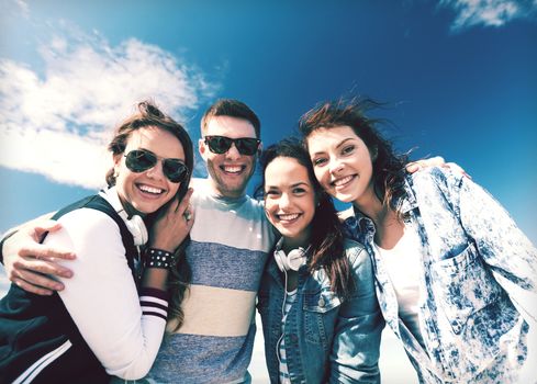 summer holidays and teenage concept - group of teenagers outside