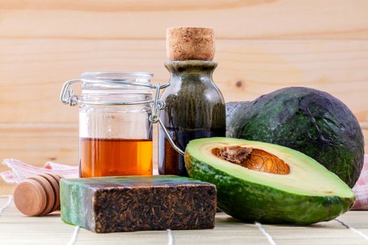 Alternative skin care  and scrub fresh  avocado , oils , honey  and  avocado soap on wooden background.