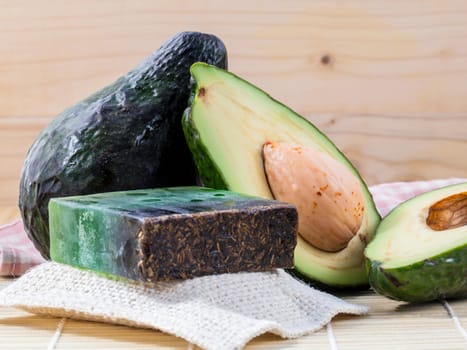 Alternative skin care  and scrub fresh  avocado  and  avocado soap on wooden background.