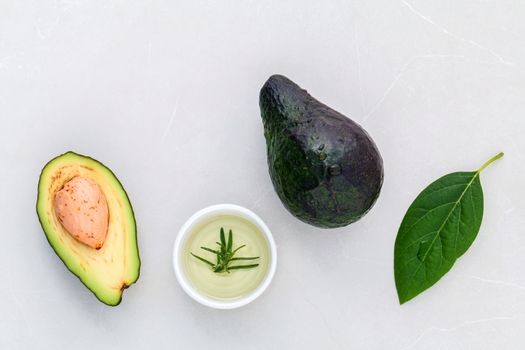 Alternative health care fresh  avocado and leaves on marble background.