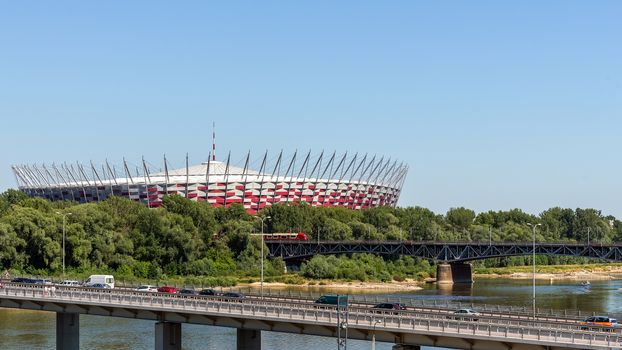 The Polish National Stadium in Warsaw preceded by the bridges over Vistula river. Designed and constructed for UEFA EURO 2012 tournament co-hosted by Poland and Ukraine.