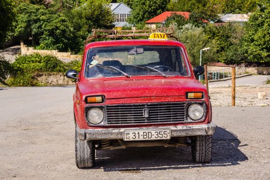 Old Lada taxi parked in the middle of the street in Baskal on September 14, 2012. Lada cars produced in former USSR are still used by taxi drivers in Azerbaijan.
