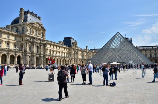 Paris, France - May 13, 2015: Tourist visit Louvre museum on May 13, 2015 in Paris. This is one of the most popular tourist destinations in France.