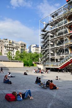 Paris, France - May 14, 2015: People relaxing at plaza in front of  Centre of Georges Pompidou on May 14, 2015 in Paris, France. The Centre of Georges Pompidou is one of the most famous museums of the modern art in the world.