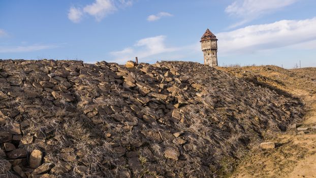 Stone railway embankment and water tower in former, devastated Uthemann Ironwork in Katowice, Silesia region, Poland