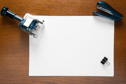 stamp and a blank sheet of paper on an office desk close up