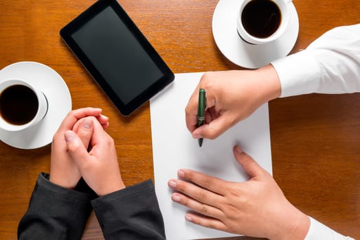 business partners hands on the table top view