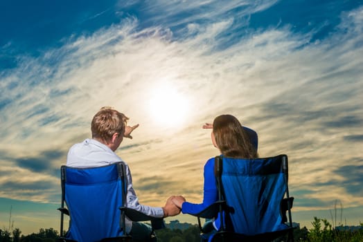 man showing finger girl something in the sky