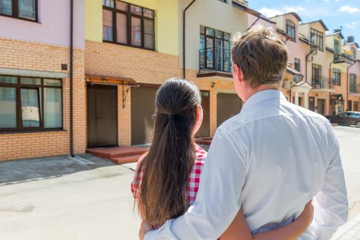 married couple looking at their new home