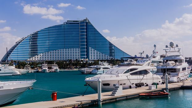 Jumeirah Beach Hotel in Dubai, preceded by the luxury marina, on February 3, 2013. Wave-shaped resort, next to famous Burj Al Arab, remains one of the well-known landmarks  of Dubai.