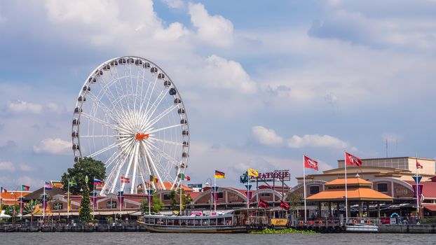 Ferris wheel in front of Asiatique The Riverfront. Asiatique is the largest lifestyle outdoor shopping mall in Bangkok by Chao Phraya river.