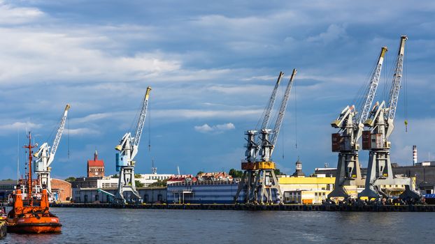 Cranes on the quay on July 11, 2013, in the Port of Gdansk - the largest seaport in Poland, a major transportation hub in the central part of the southern Baltic Sea coast.
