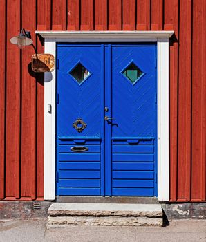 Blue dorway of a residential house, exapmle of typical Swedish traditional architecture.