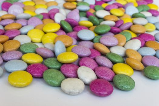 Sugar coated pills,chocolate dragees on a white background
