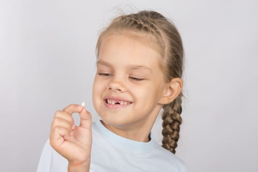 Six year old girl showing her fallen Milk front upper teeth