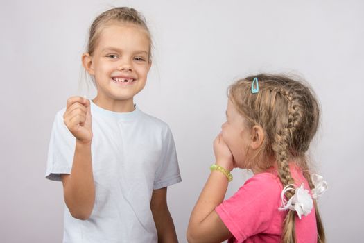 Six year old girl showing her the other girl had fallen Milk front upper teeth